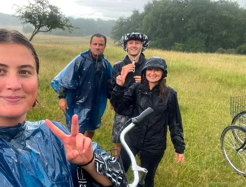 Wild deer grazing near a Copenhagen bike tour group in Dyrehaven
