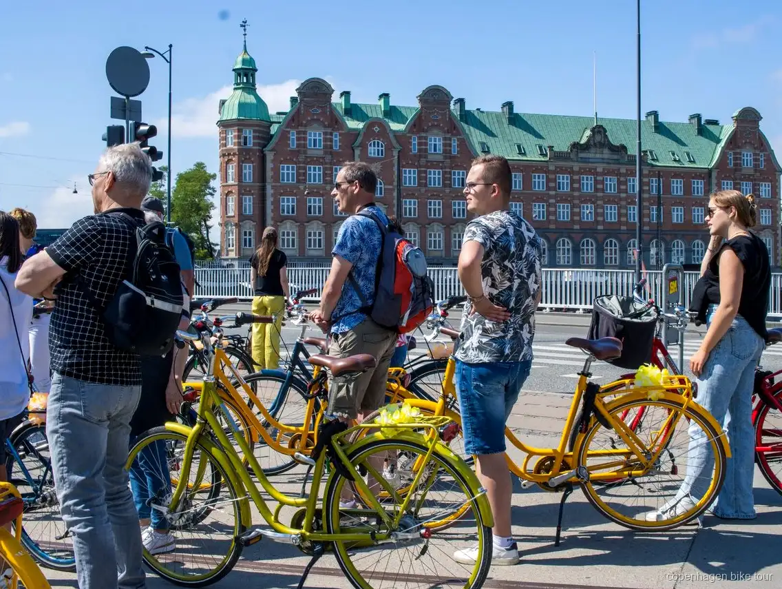 Riders passing Christiansborg Palace on a guided Copenhagen bike tour