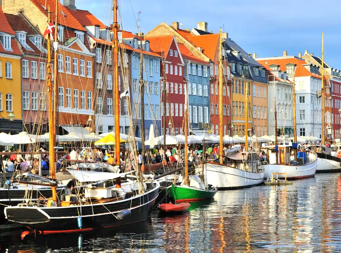 Group stopped near the Little Mermaid statue on a Copenhagen bike tour