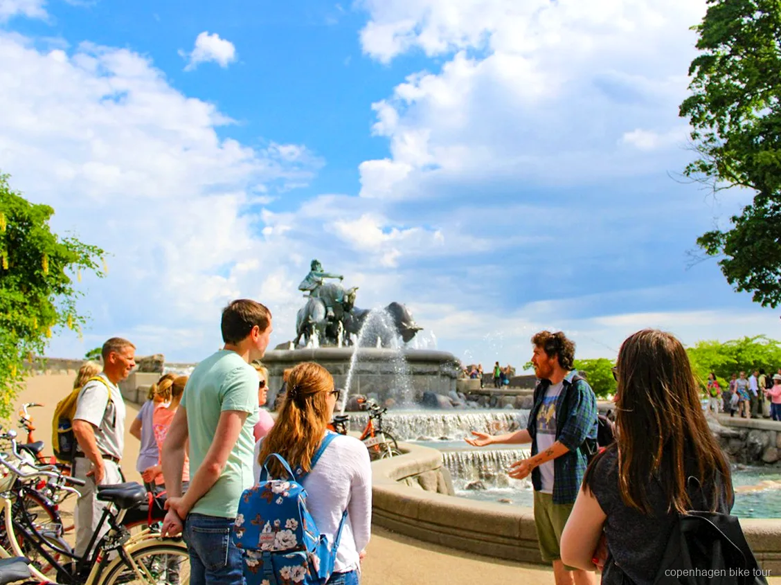 Small group cycling across Inderhavnsbroen on a Copenhagen top sights bike tour