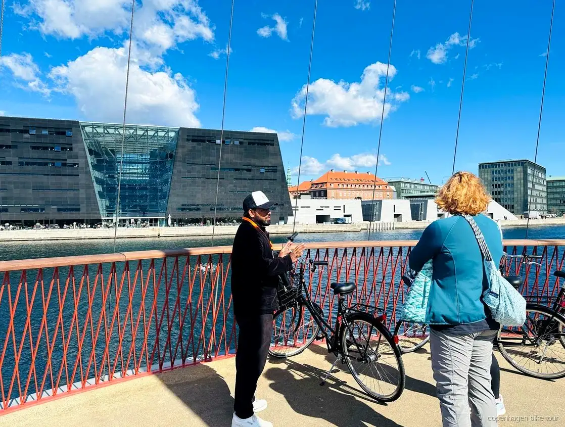 Guide som förklarar Christianias historia för en liten cykelgrupp i Köpenhamn
