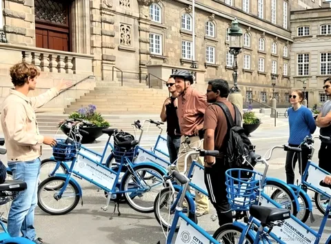 Ciclistas pasando por el Palacio de Amalienborg durante un tour en bici rápido por Copenhague