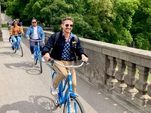 Ciclisti che passano davanti alle case colorate di Nyhavn durante un breve tour in bici a Copenaghen